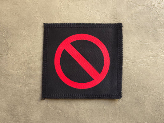 Black handmade screen printed crossed circle symbol patch with high-contrast printed graphic