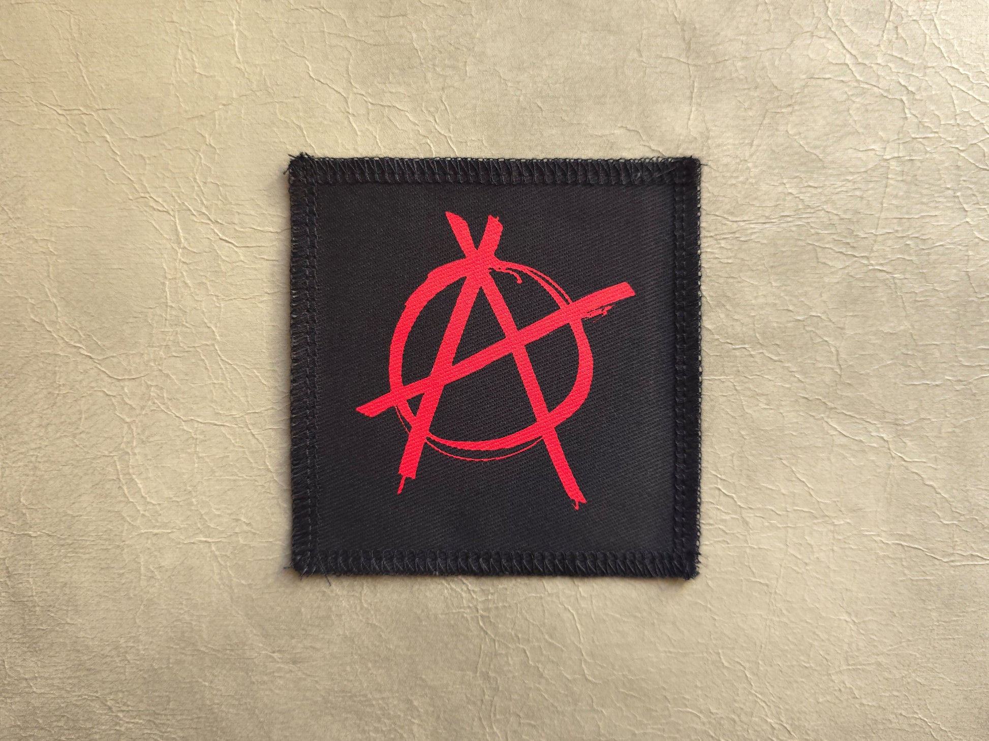 Black handmade screen printed anarchy symbol patch with high-contrast printed graphic