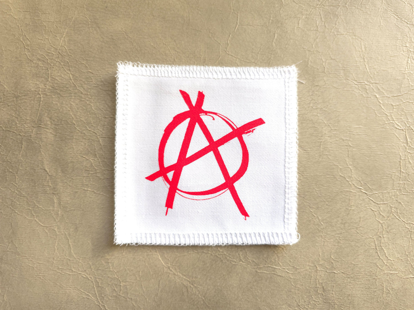 White handmade screen printed anarchy symbol patch with crisp printed design