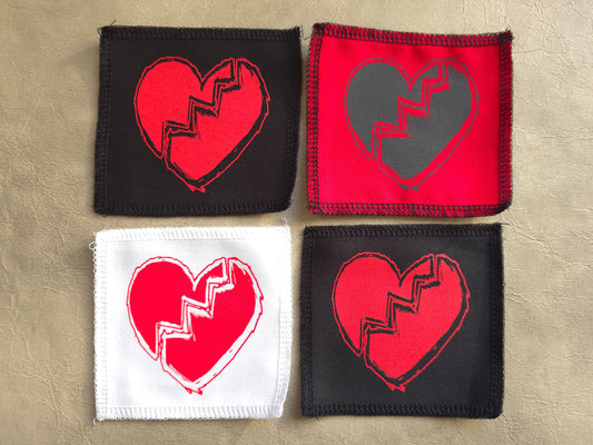 Handmade screen printed broken heart symbol patch, front view showing detailed ink design on fabric