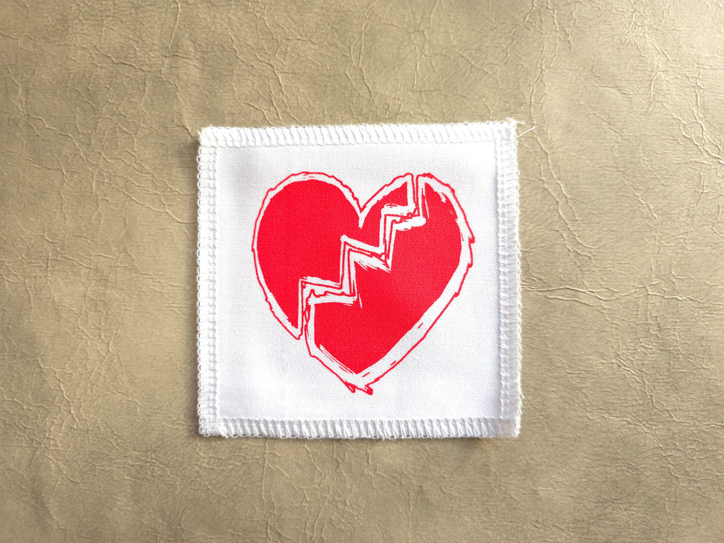 White handmade screen printed broken heart symbol patch with crisp printed design
