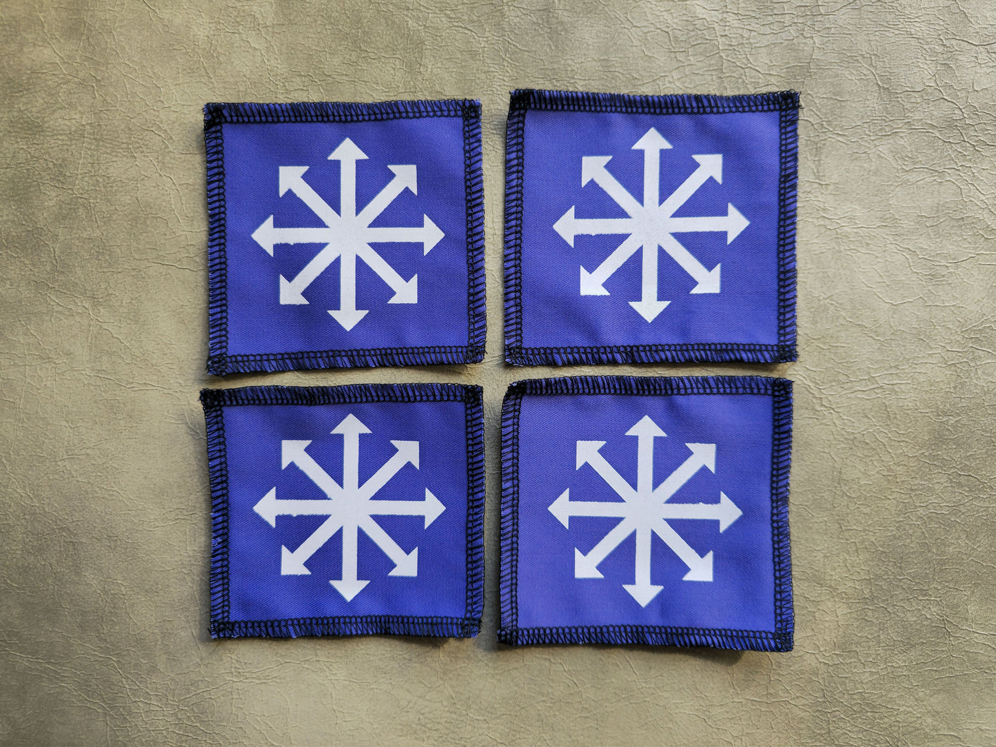 Purple handmade screen printed chaos symbol patches shown together
