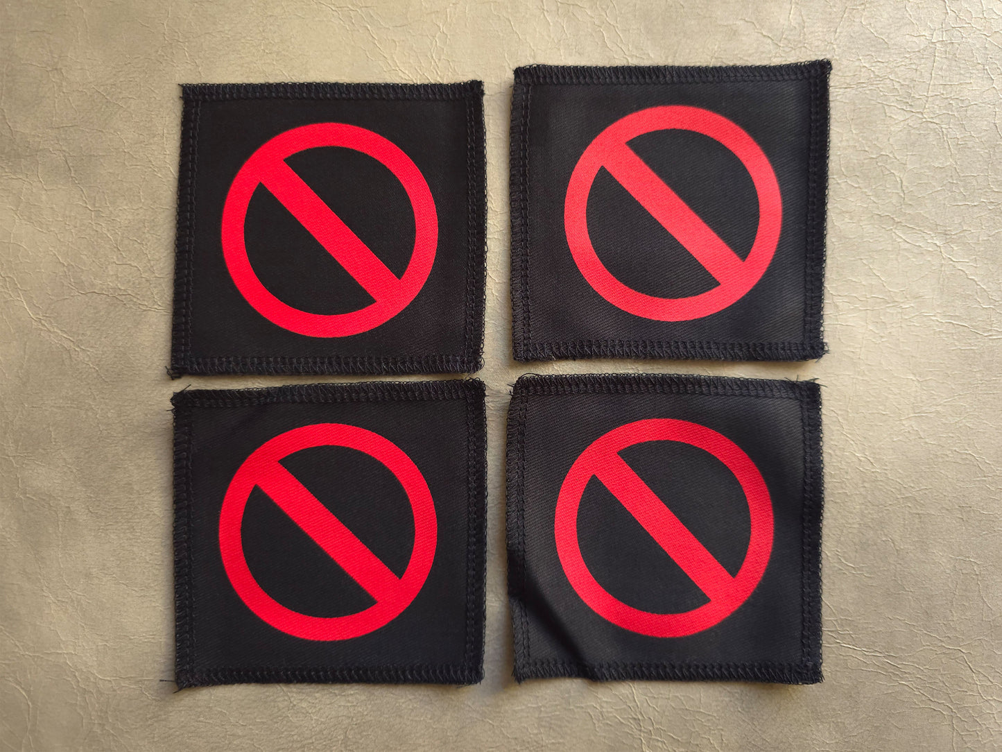 Black handmade screen printed do not symbol patches displayed together