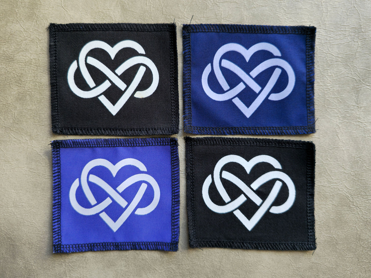 Handmade forever love symbol sew-on patch, screen printed on black, blue or violet cotton twill with stitched border