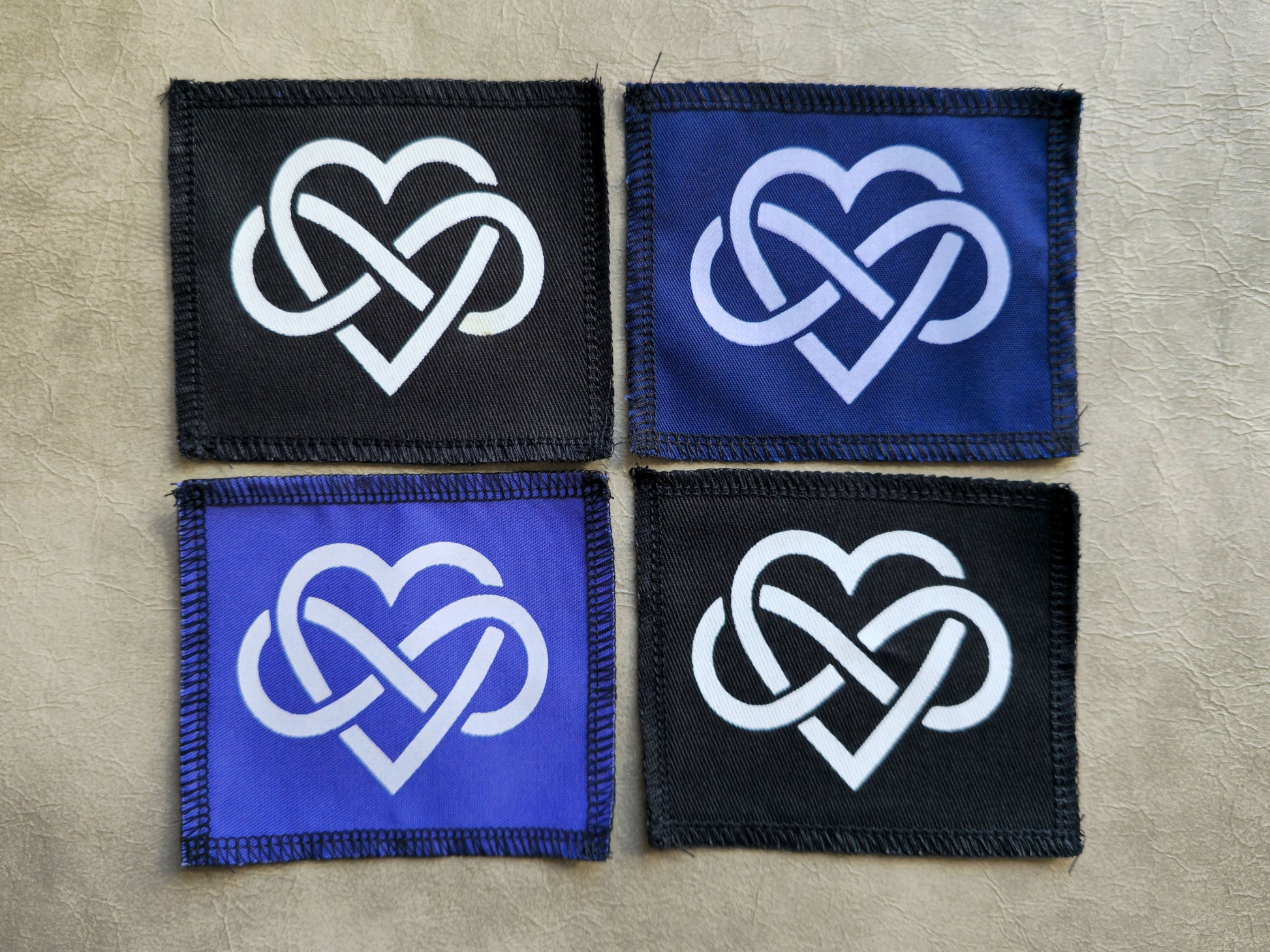 Handmade forever love symbol sew-on patch, screen printed on black, blue or violet cotton twill with stitched border