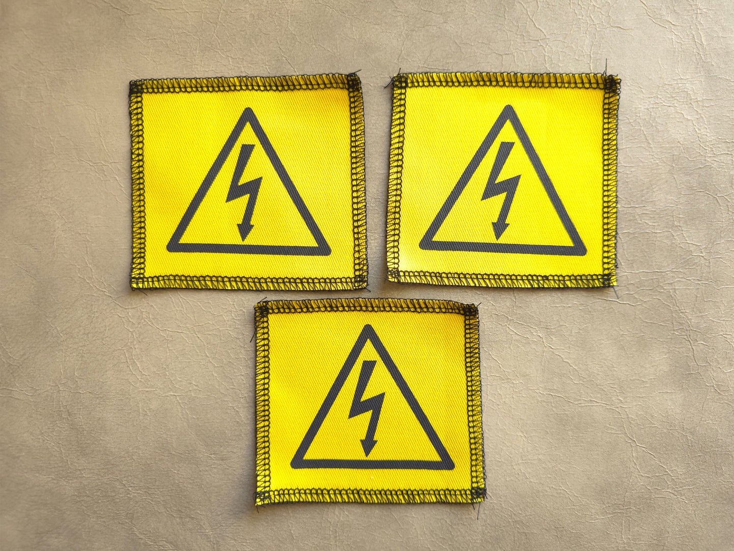 Set of yellow handmade screen printed symbol patches displayed together