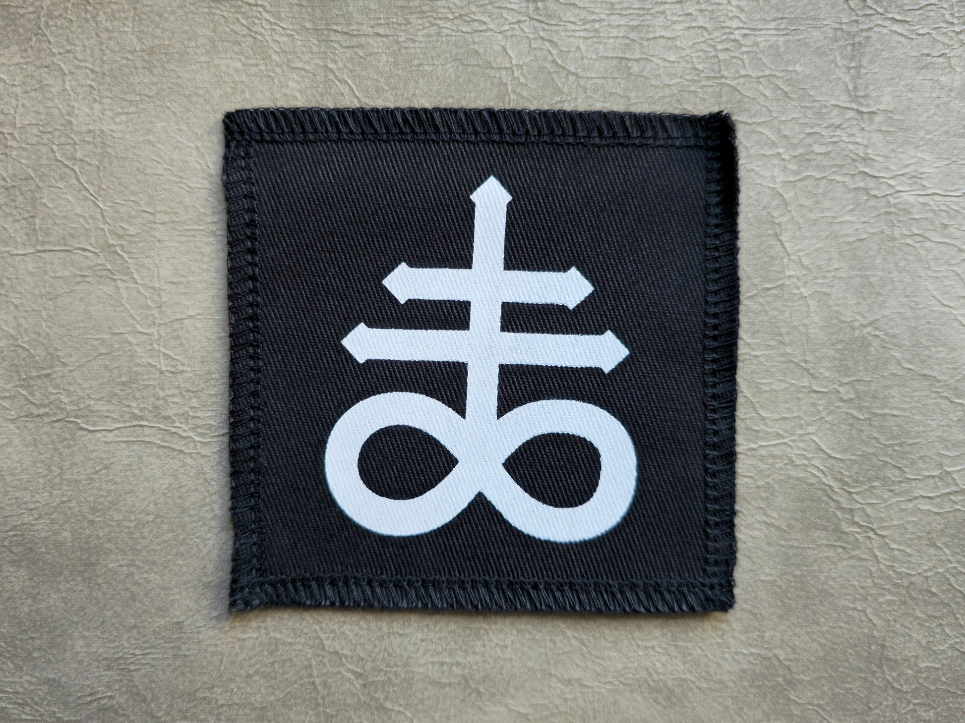 Black handmade screen printed leviathan symbol patch with high-contrast printed graphic