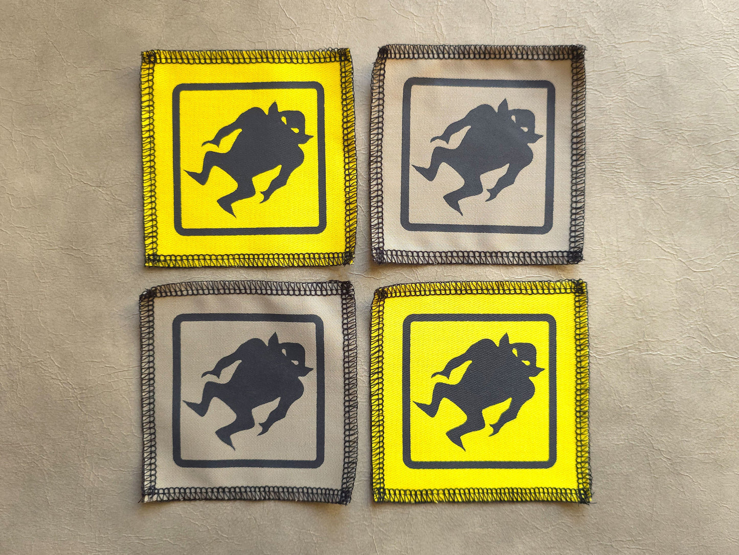 Handmade screen printed monster symbol patch, front view showing detailed ink design on fabric