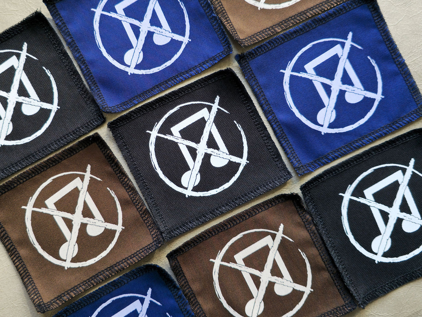 Angled view of handmade screen printed noise not music symbol patch highlighting fabric texture and print detail