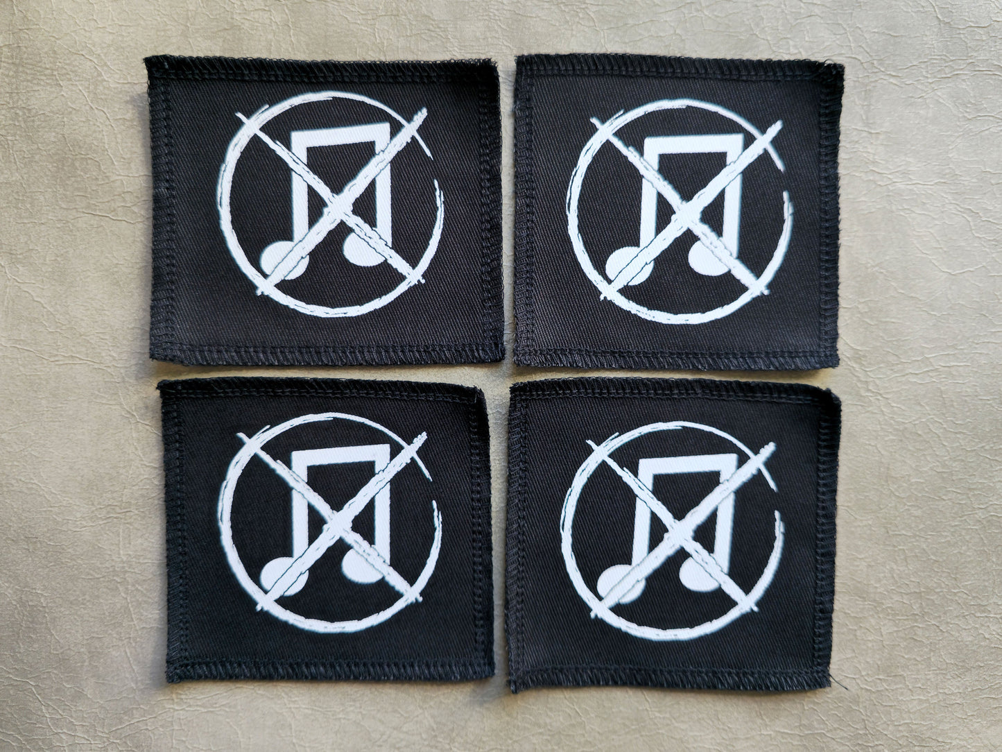 Black handmade screen printed noise not music symbol patches displayed together