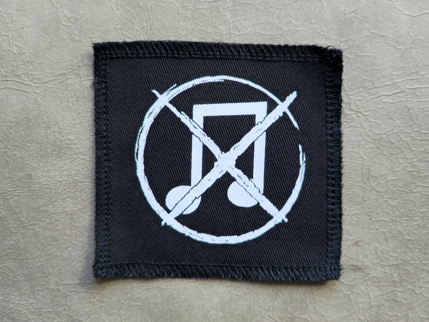 Black handmade screen printed noise not music symbol patch with high-contrast printed graphic