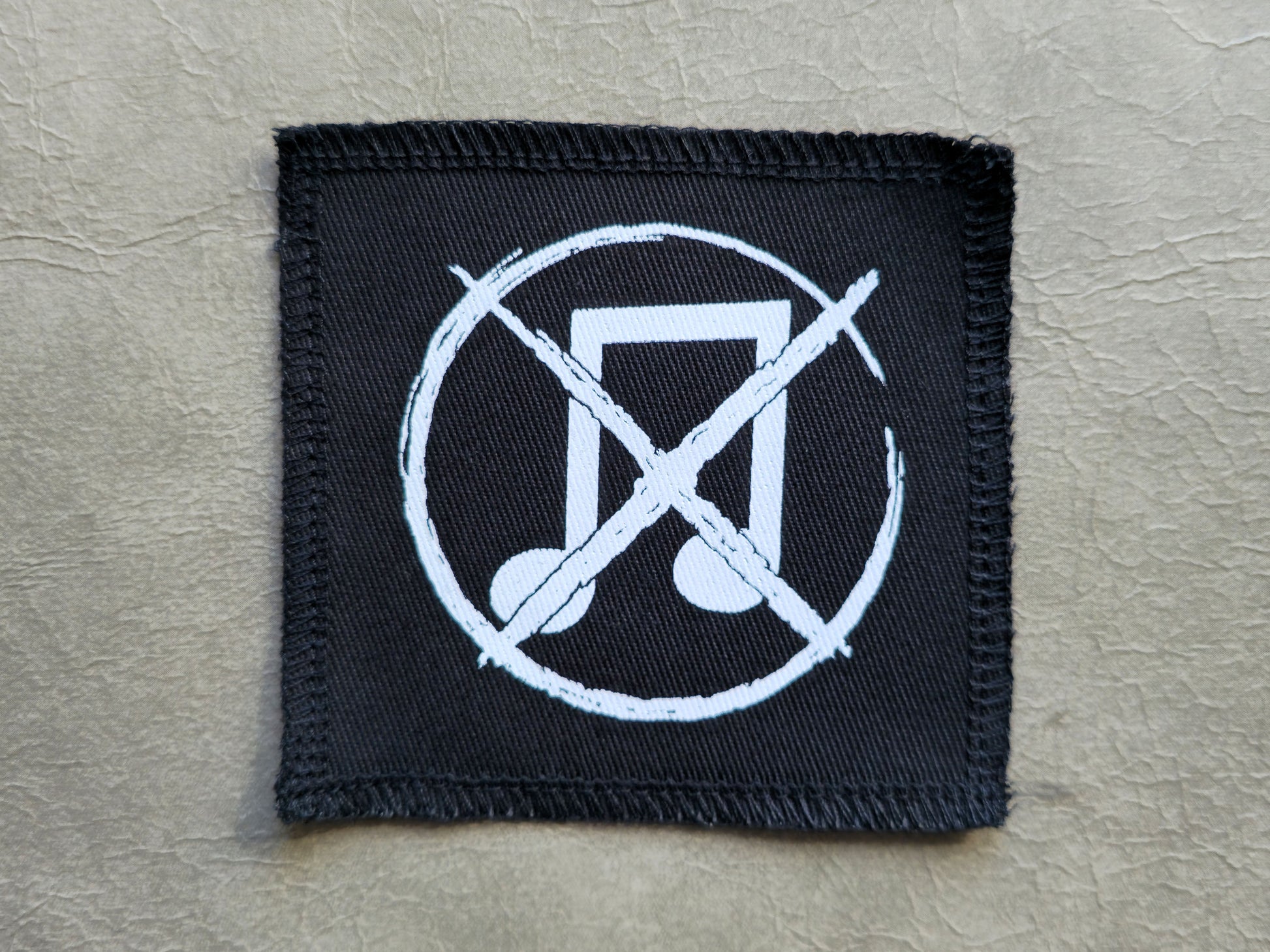 Black handmade screen printed noise not music symbol patch with high-contrast printed graphic