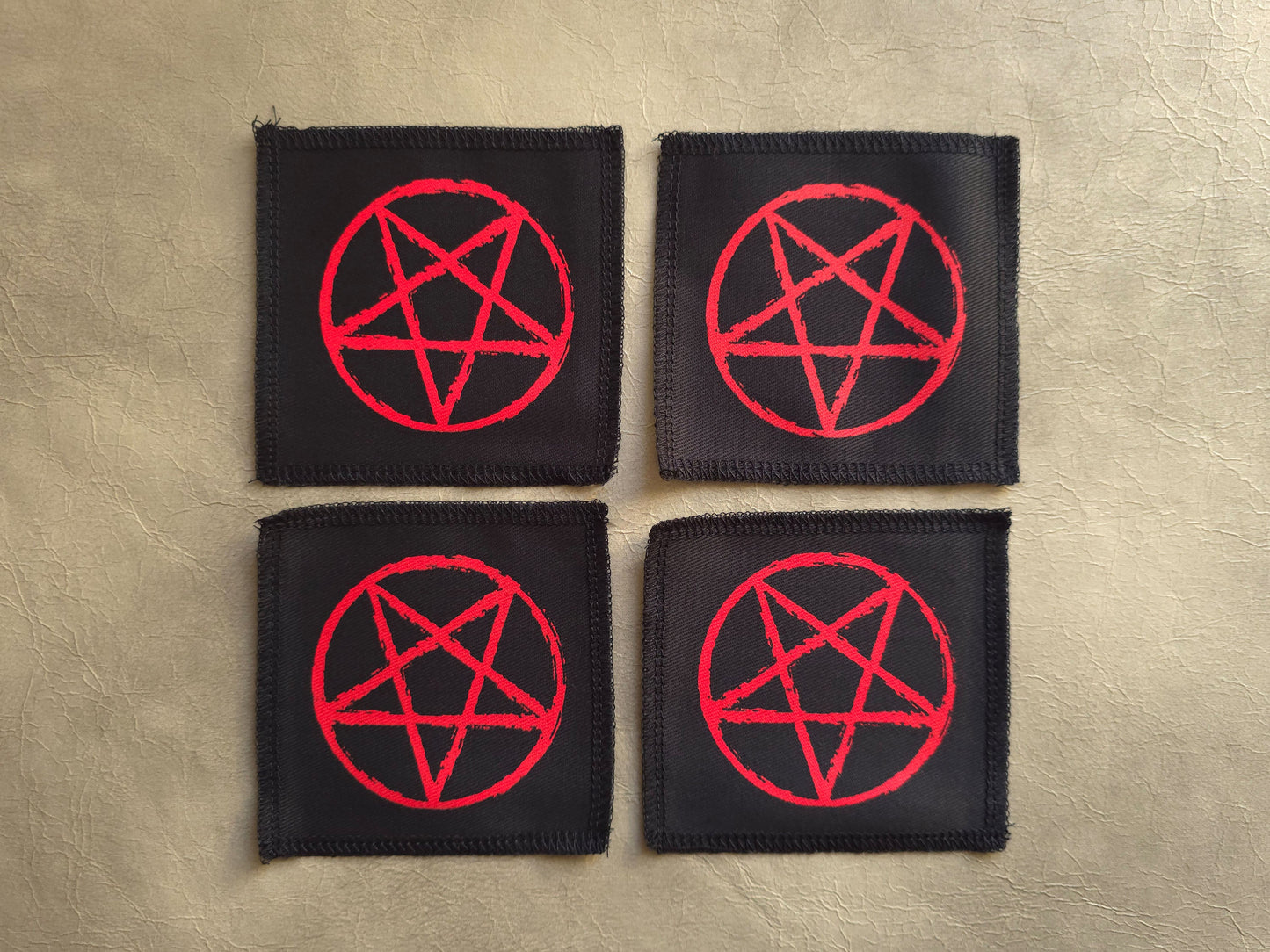 handmade screen printed black patches with red pentagram symbols 
