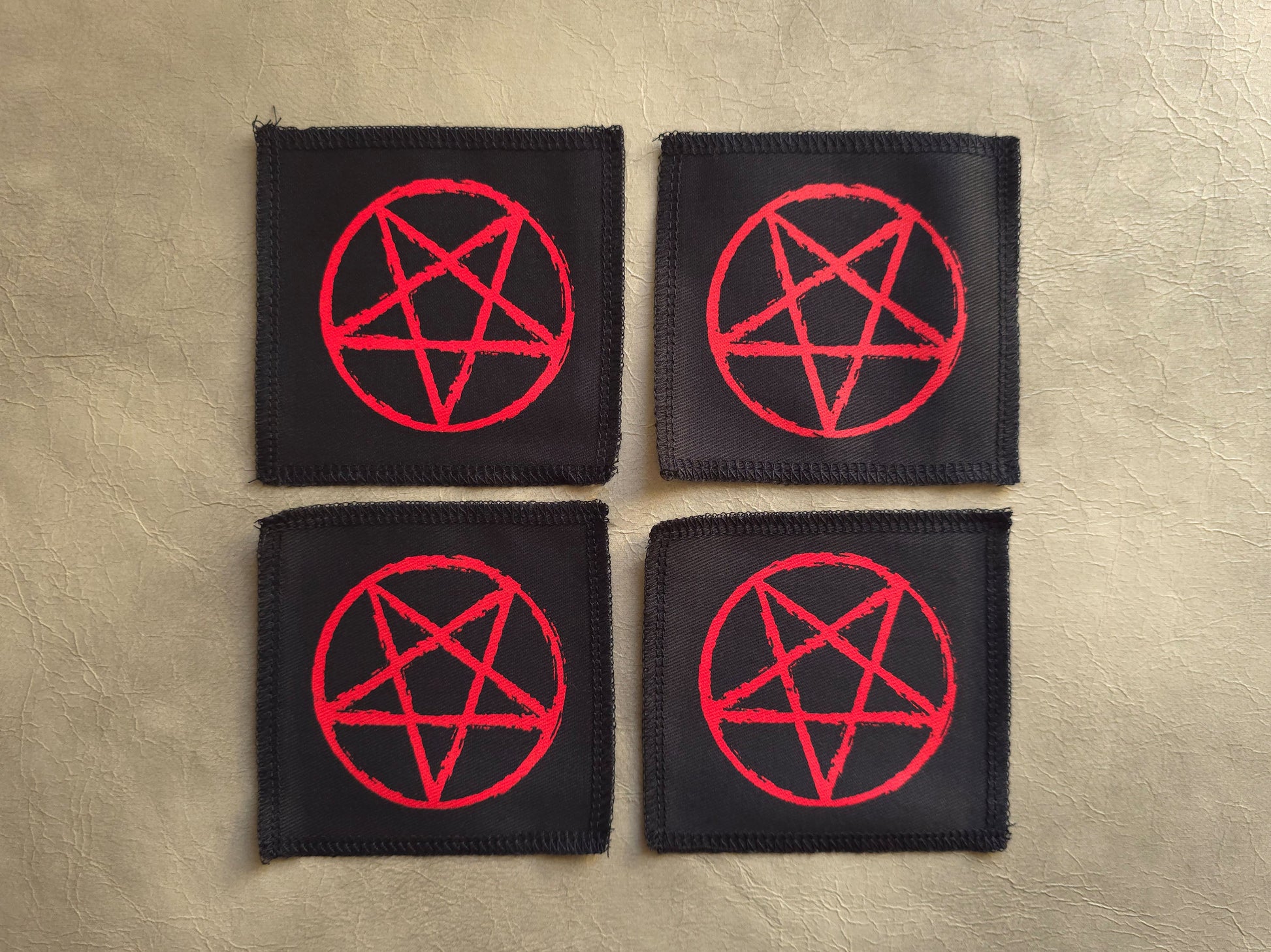 handmade screen printed black patches with red pentagram symbols 