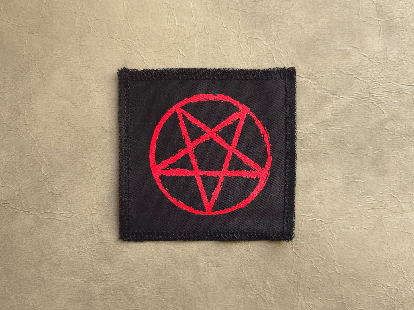 handmade screen printed Black patch with a red pentagram symbol