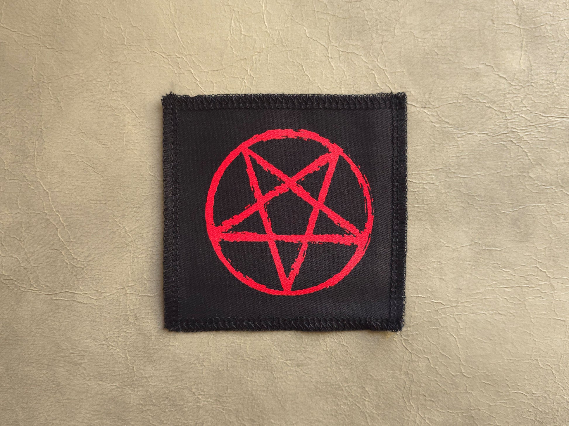 handmade screen printed Black patch with a red pentagram symbol