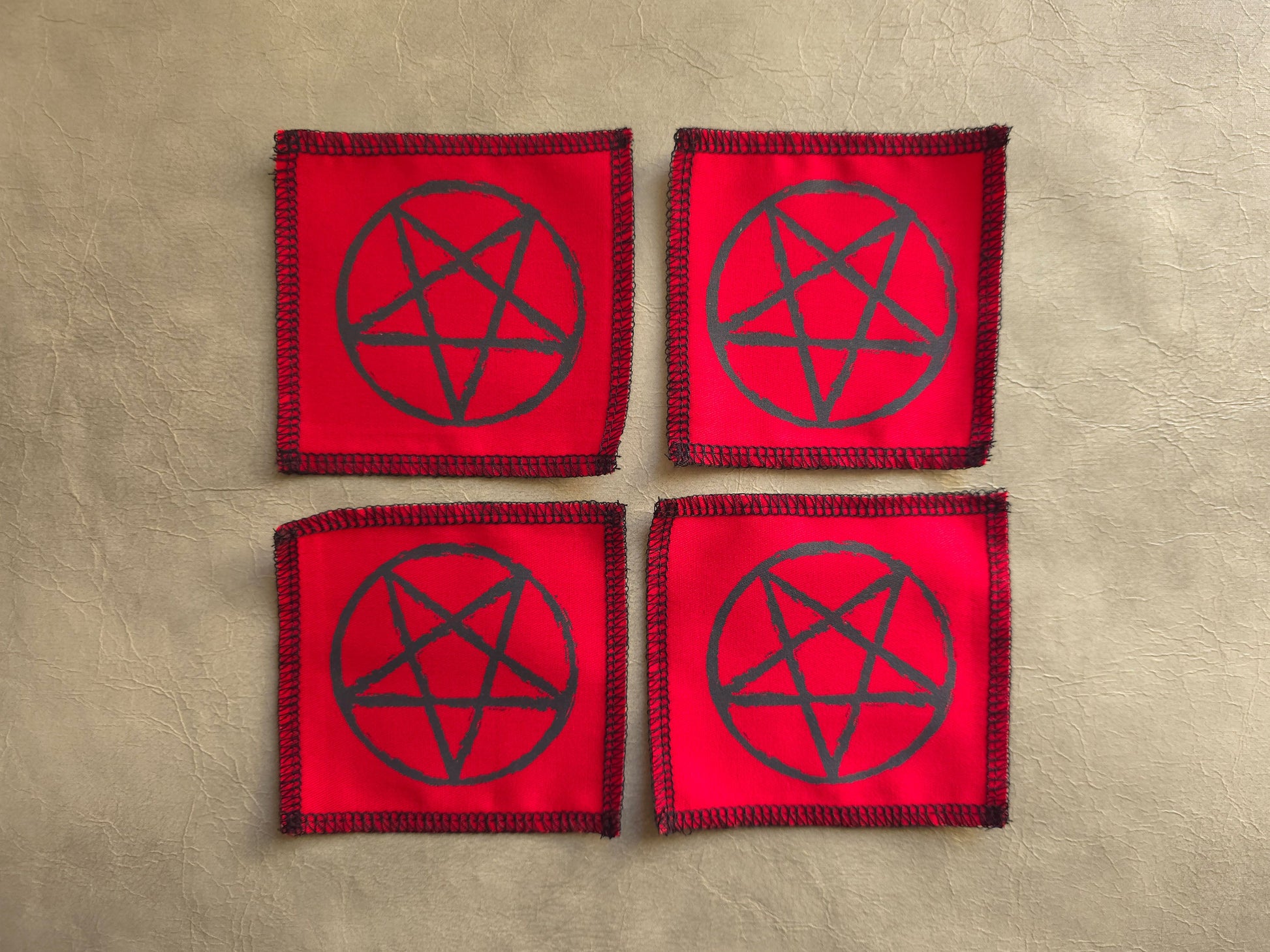 handmade screen printed red patches with black pentagram symbols 