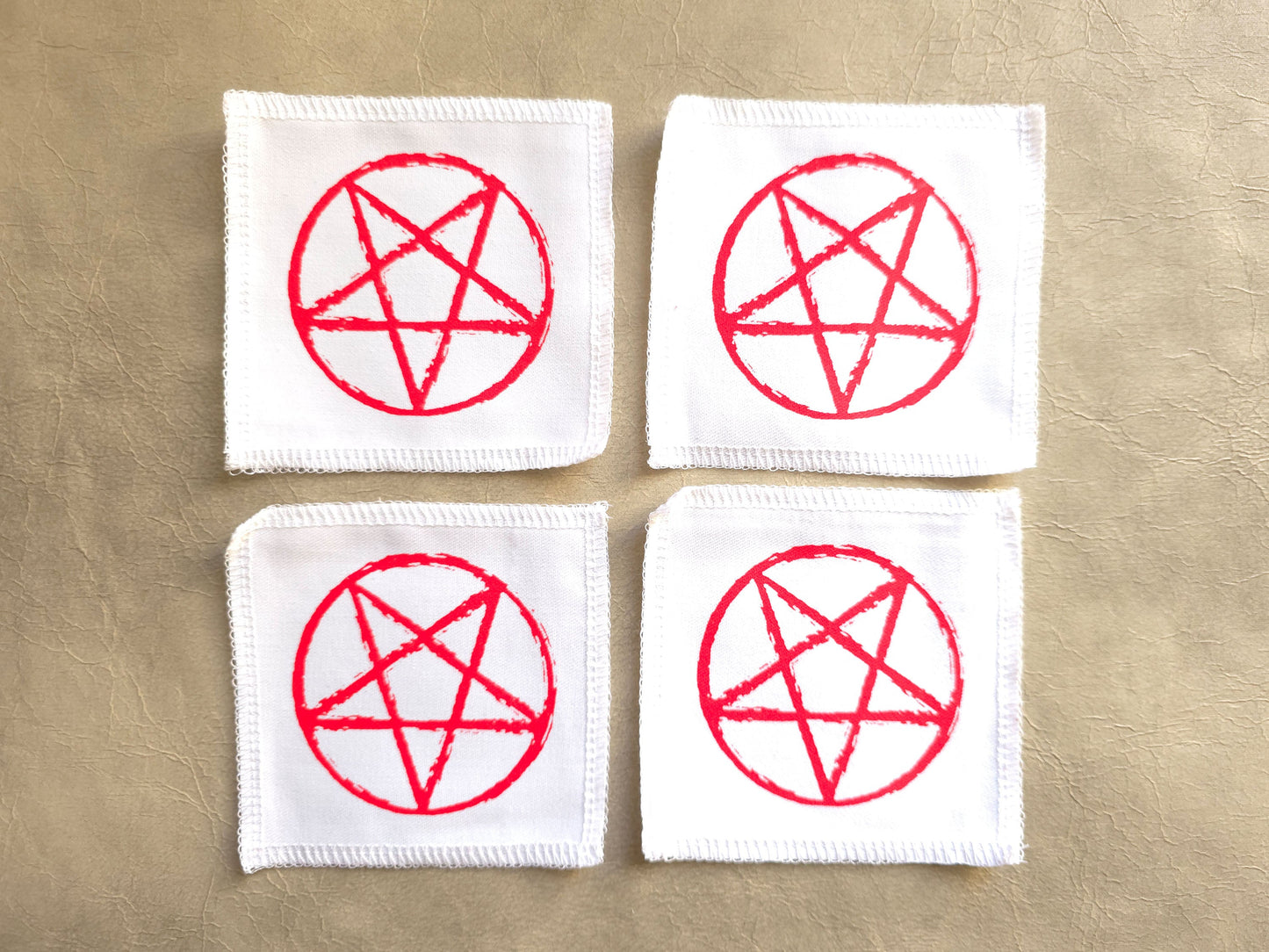 handmade screen printed white patches with red pentagram symbols