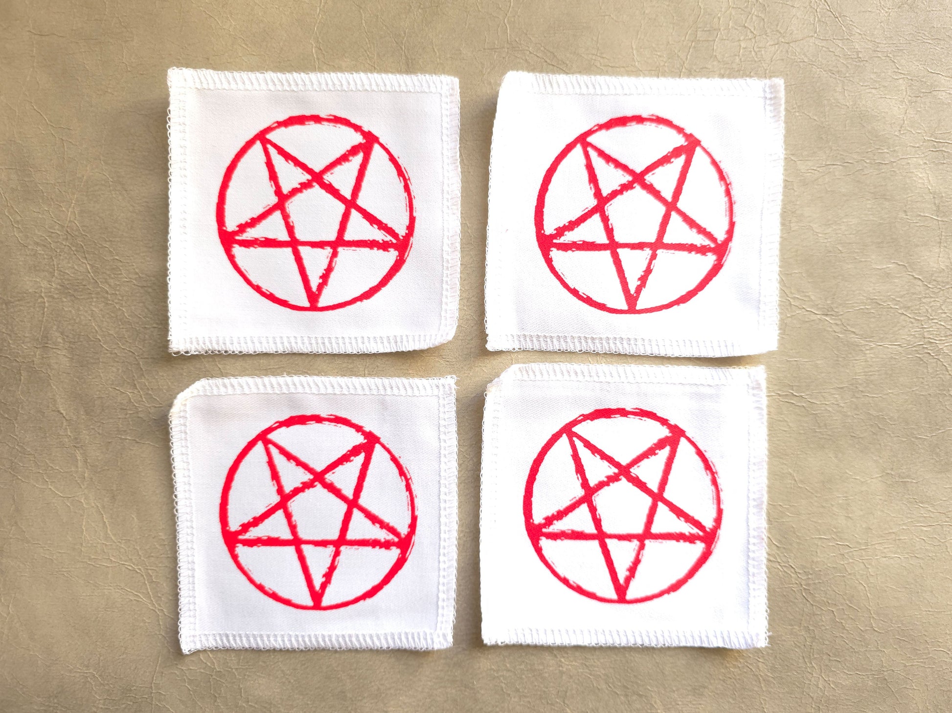 handmade screen printed white patches with red pentagram symbols