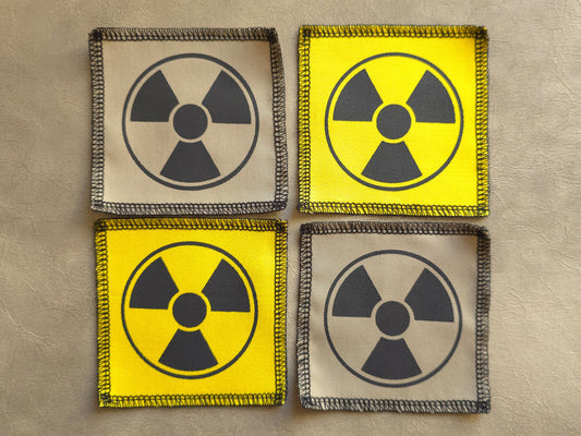 Handmade screen printed radioactive symbol patch, front view showing detailed ink design on fabric