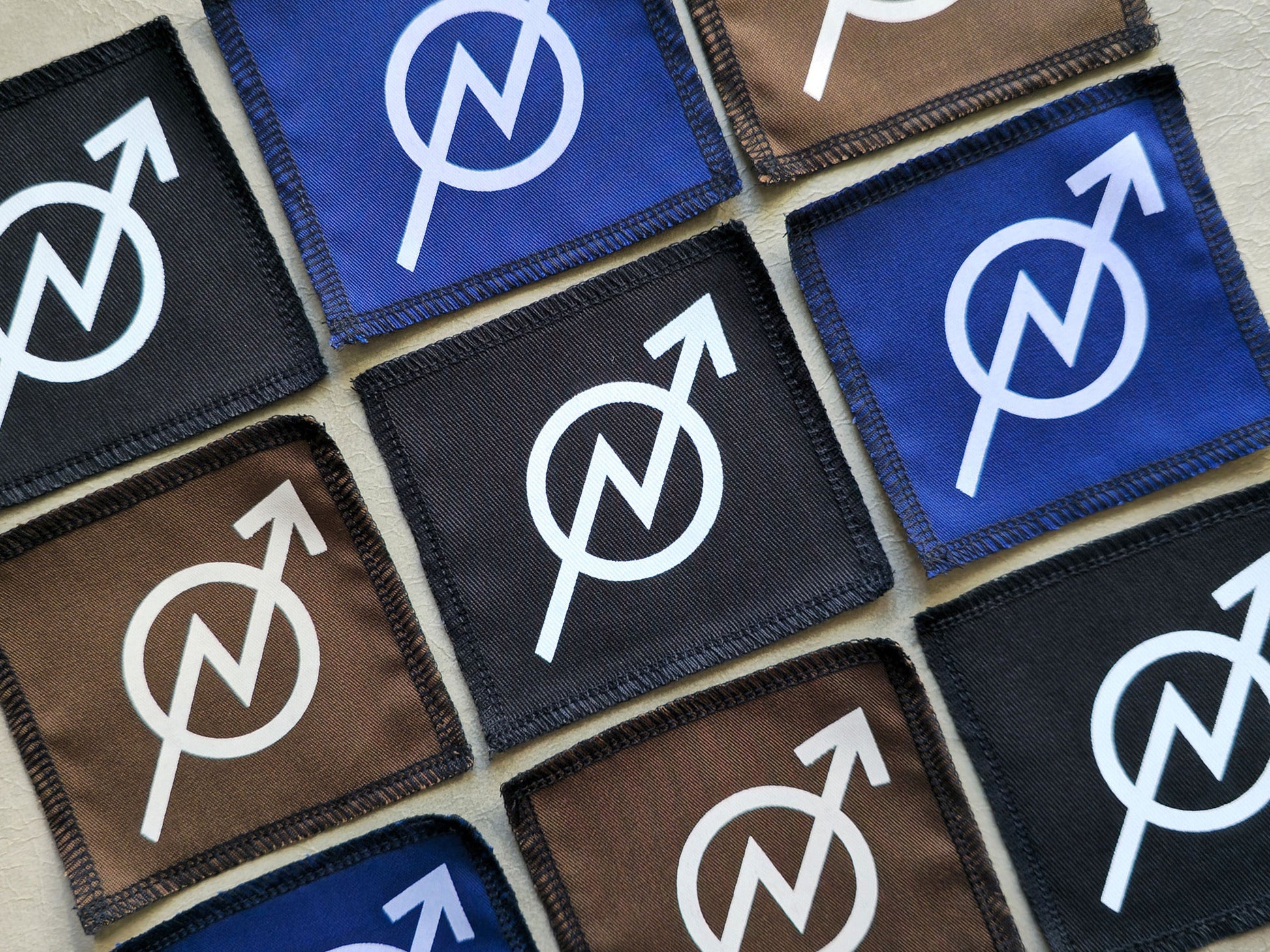 Angled view of handmade screen printed squat symbol patch highlighting fabric texture and print detail