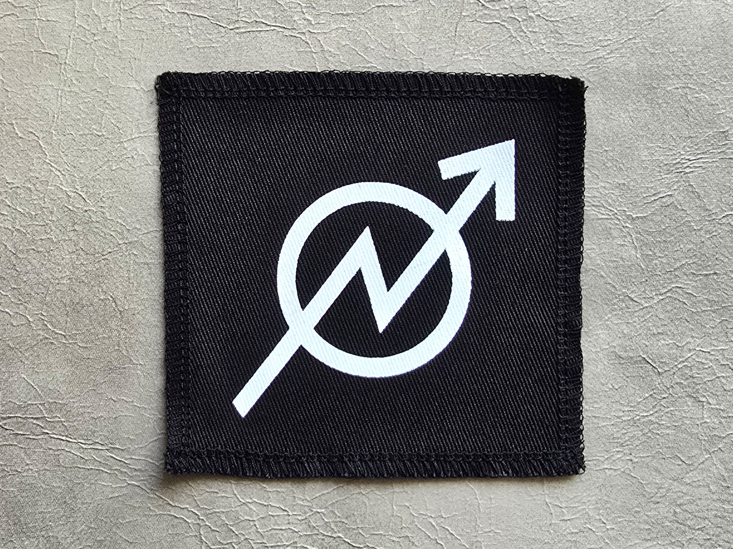 Black handmade screen printed squat  symbol patch with high-contrast printed graphic