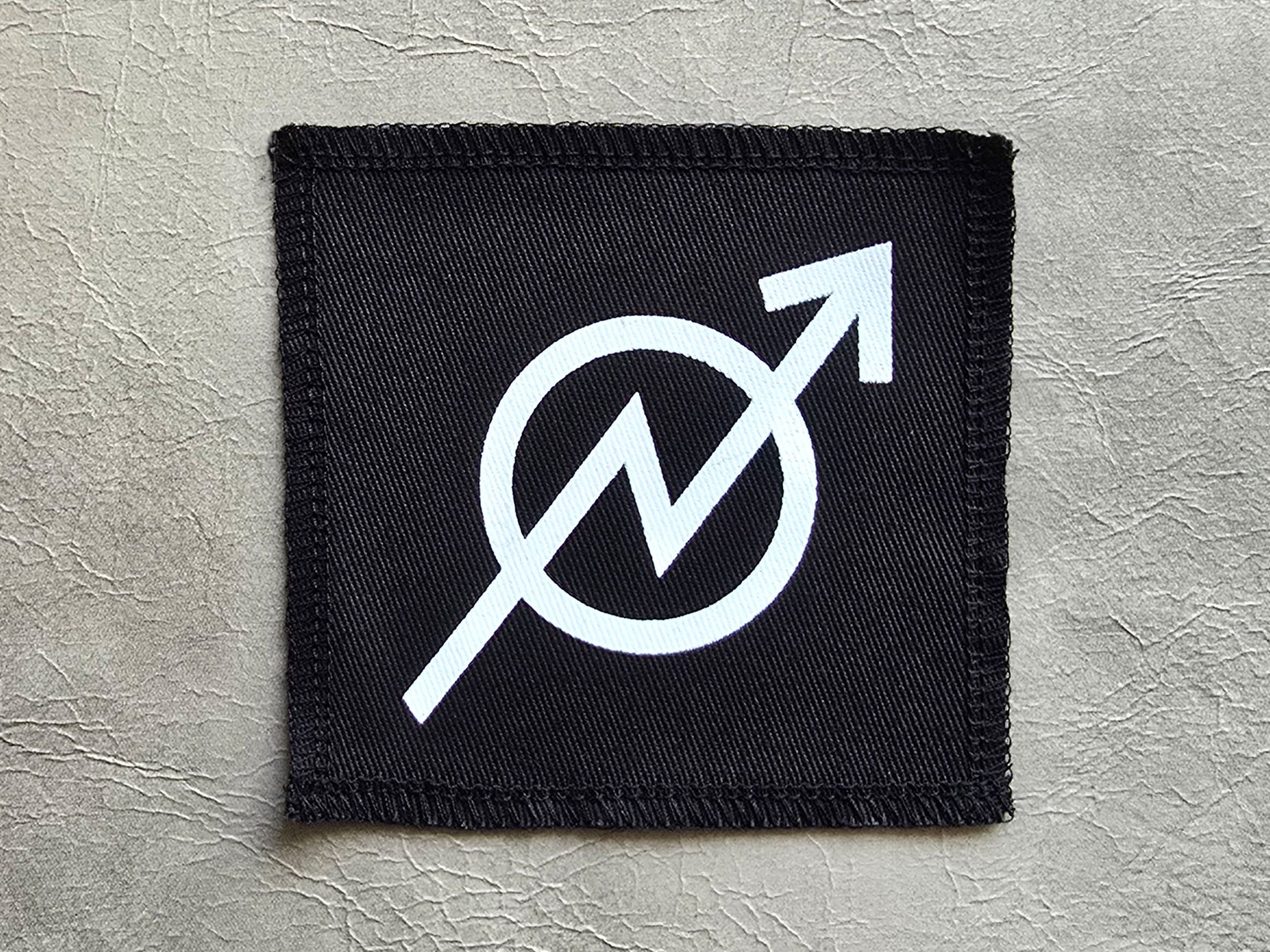 Black handmade screen printed squat  symbol patch with high-contrast printed graphic