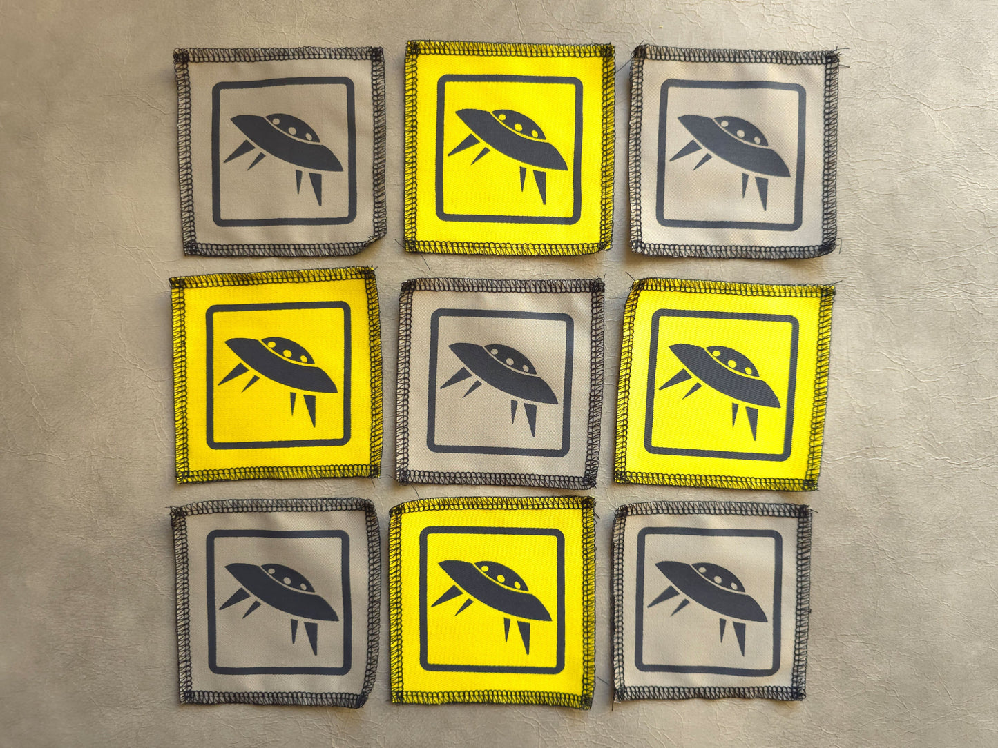 Assorted handmade screen printed symbol patches displayed together in different colors