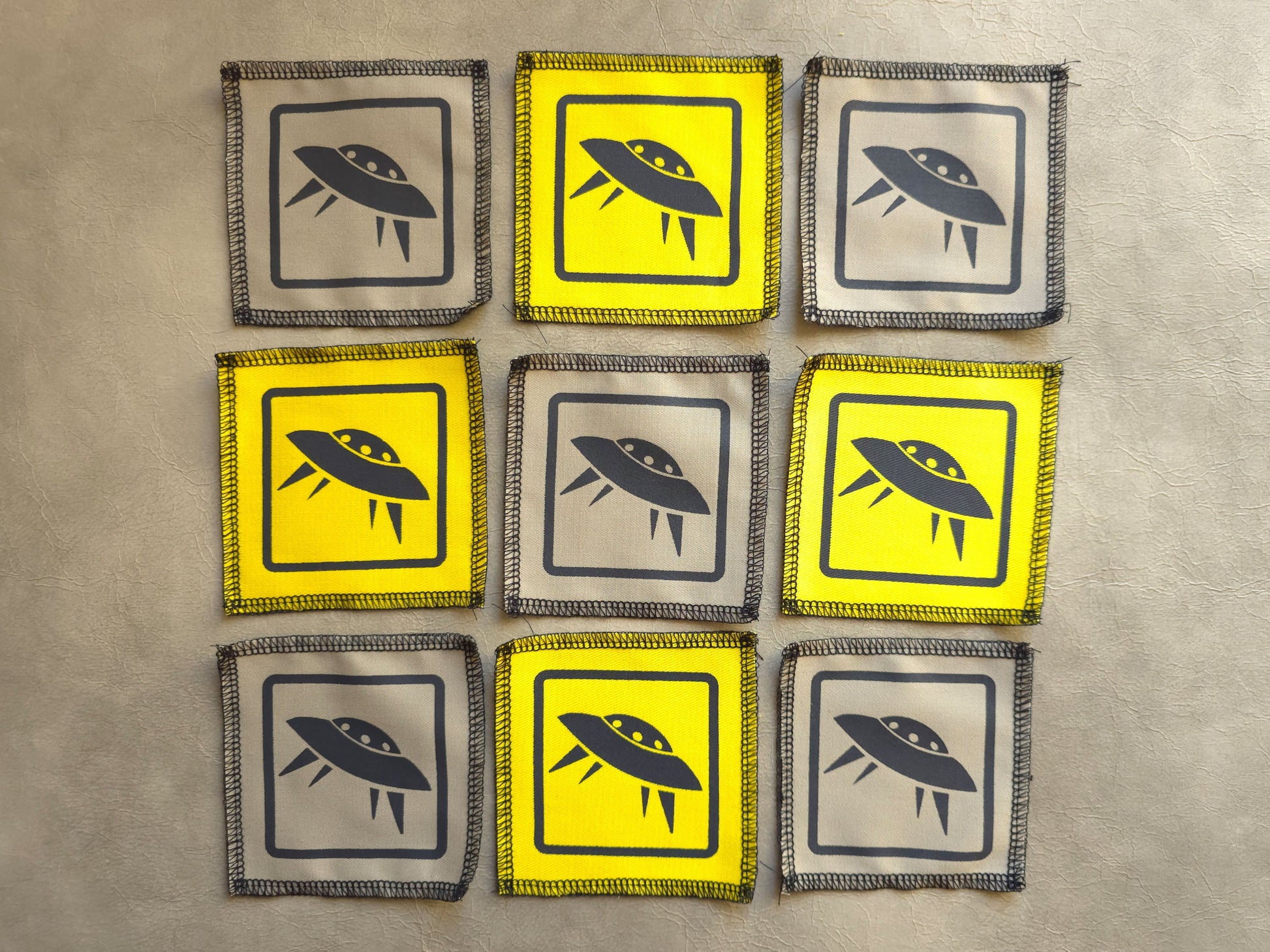 Assorted handmade screen printed symbol patches displayed together in different colors
