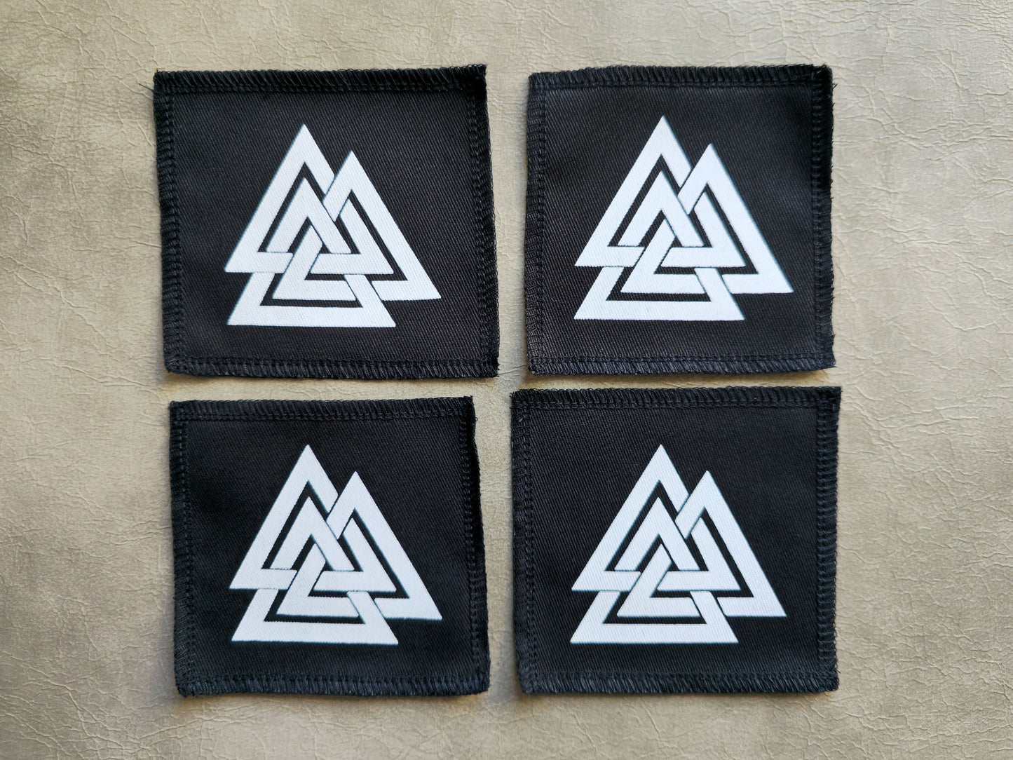 Black handmade screen printed valknut symbol patches displayed together