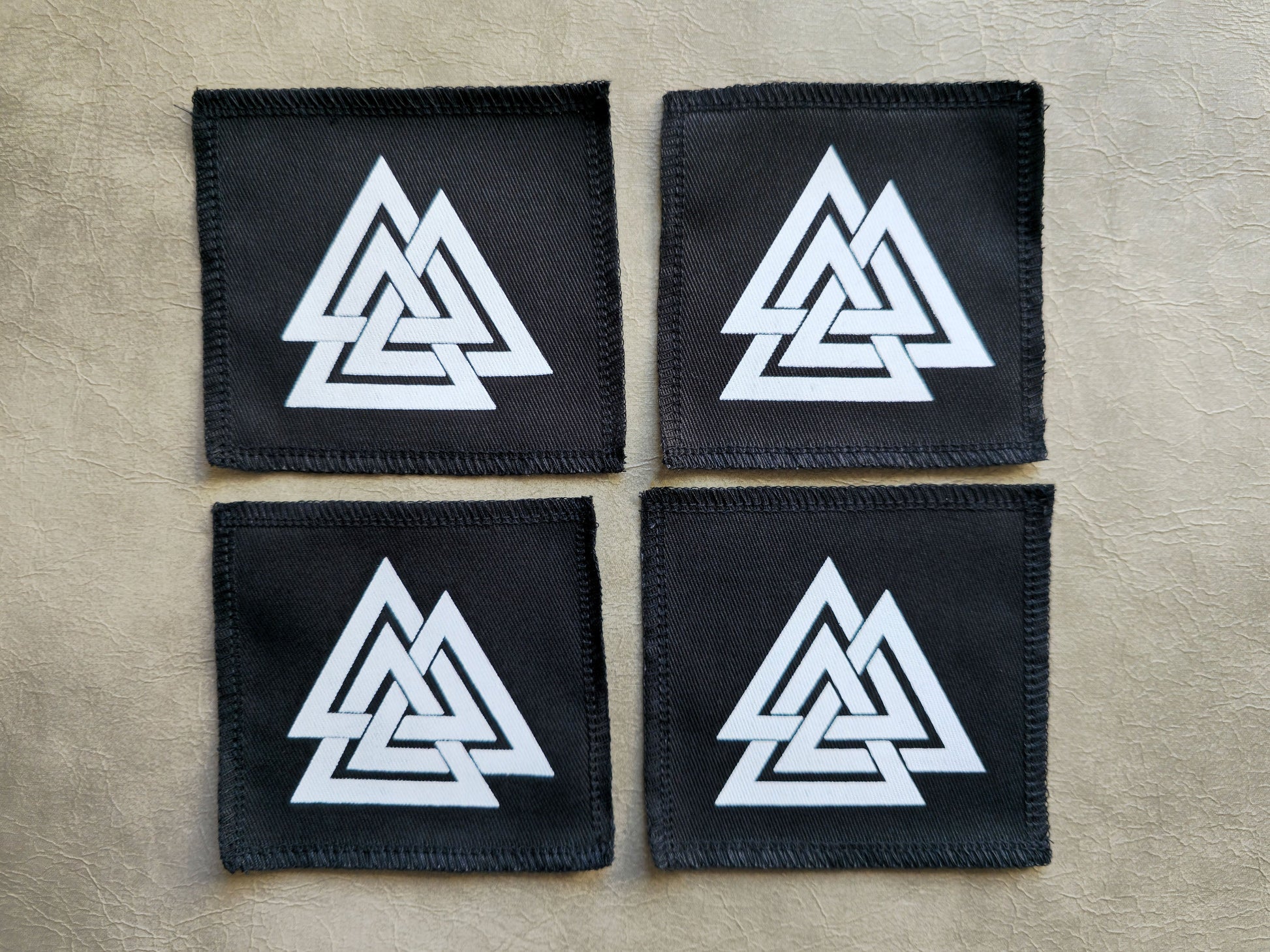 Black handmade screen printed valknut symbol patches displayed together