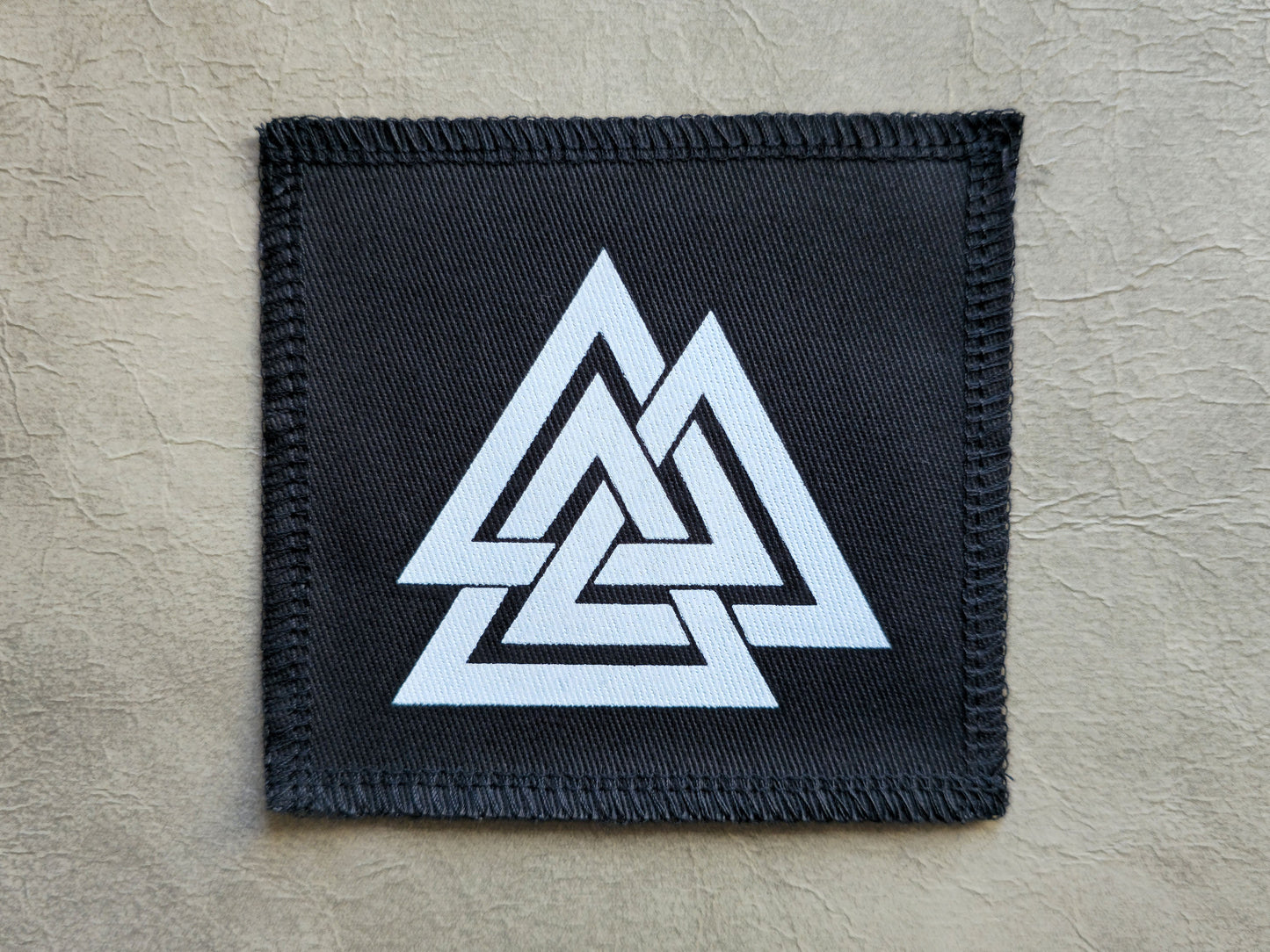 Black handmade screen printed valknut symbol patch with high-contrast printed graphic