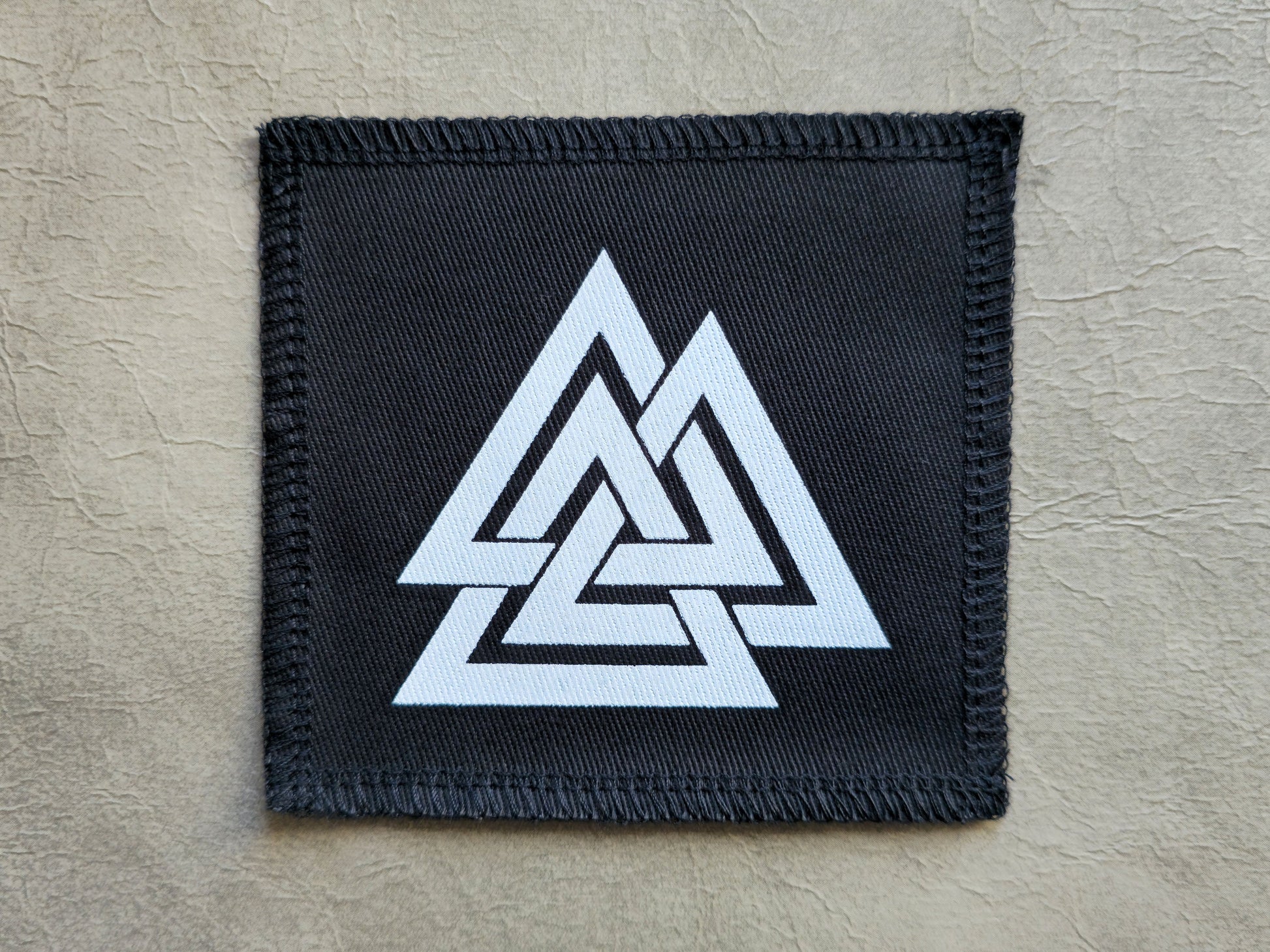 Black handmade screen printed valknut symbol patch with high-contrast printed graphic