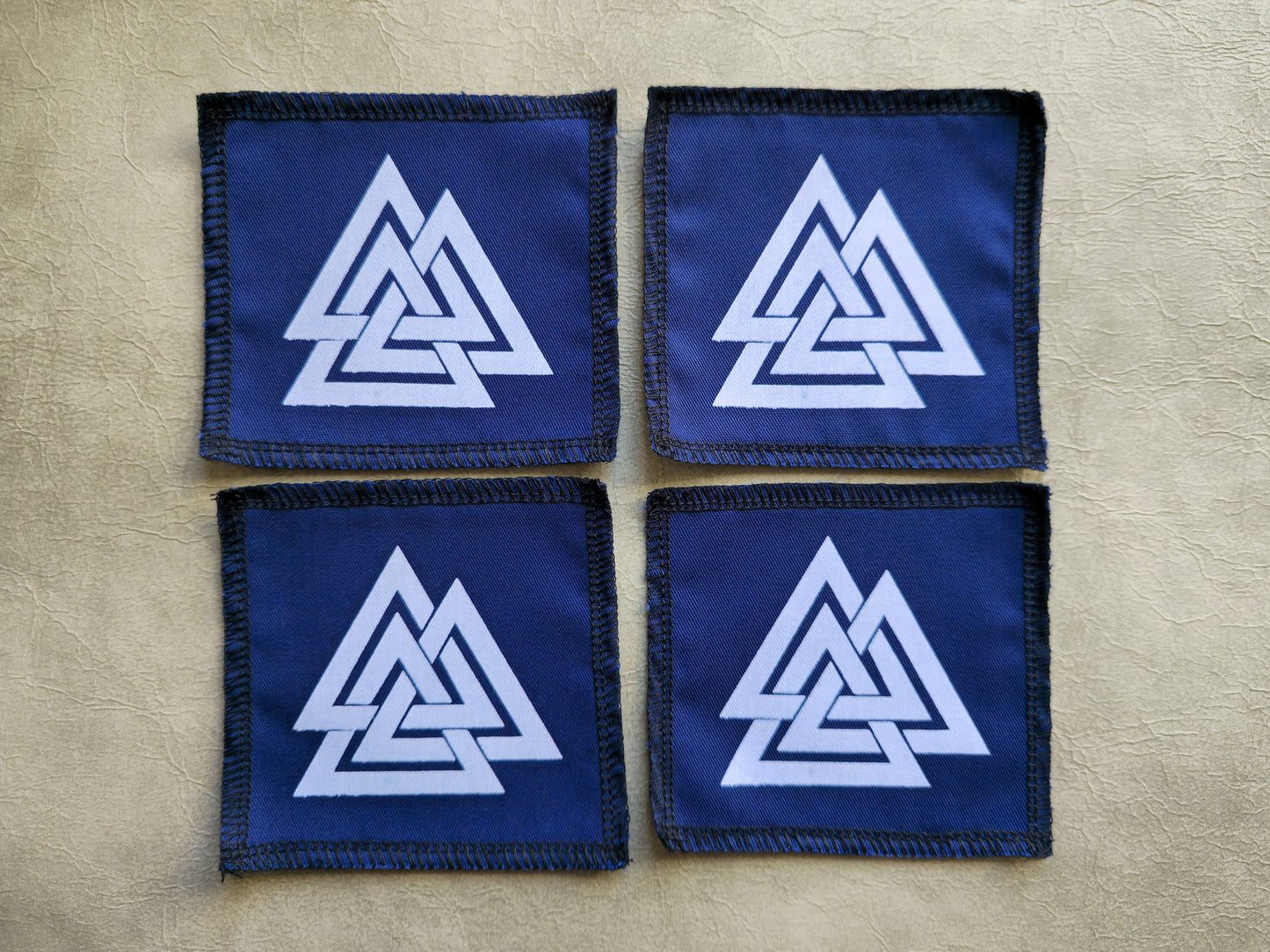 Blue handmade screen printed valknut symbol patches shown as a coordinated set