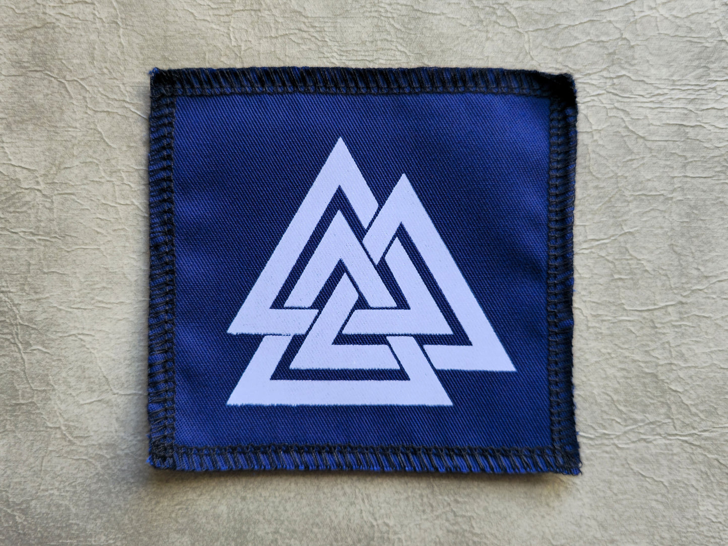 Blue handmade screen printed valknut symbol patch with contrasting ink detail