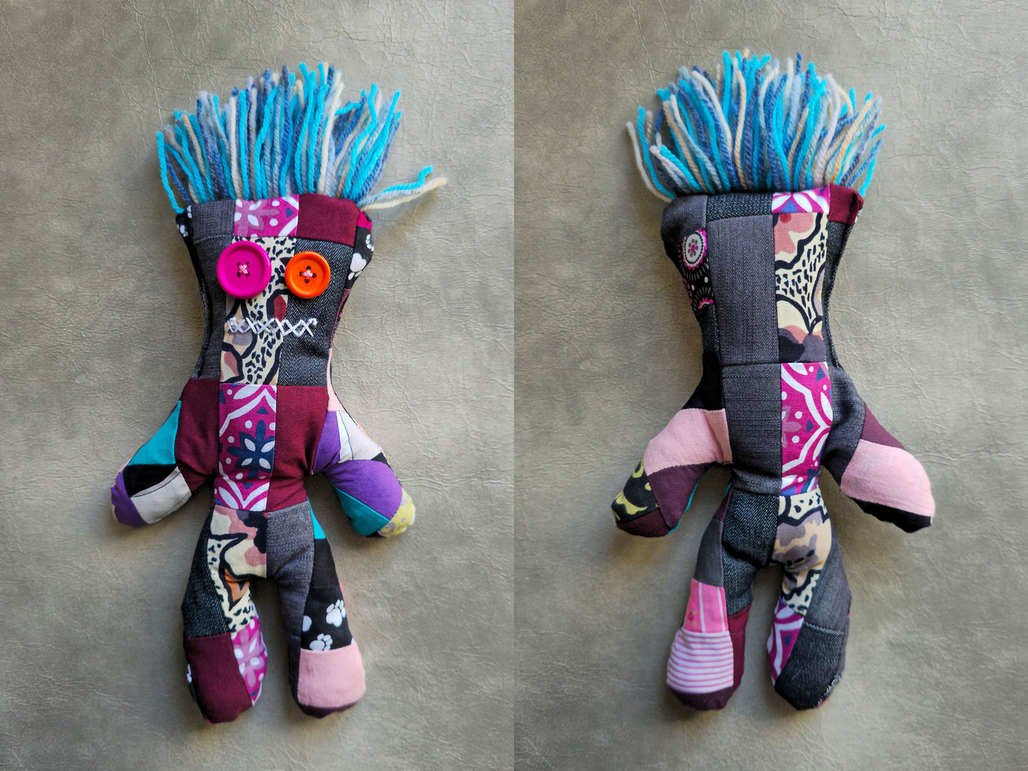 Colorful patchwork jeans and cotton made voodoo  doll with a blue woolen hair